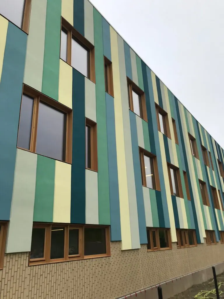 Grand Concourse Academy building in New York featuring colorful, impact-resistant StoTherm ci facade designed for durability and visual appeal.