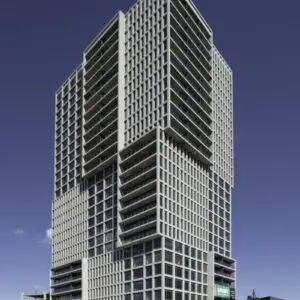 Modern High-rise Residential Tower With A Geometric Facade System Showcasing Clean Lines And Contemporary Architectural Design