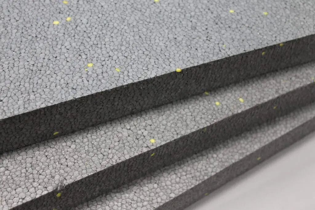 Close-up of stacked Sto GPS insulation boards showing the gray foam material with visible graphite beads.