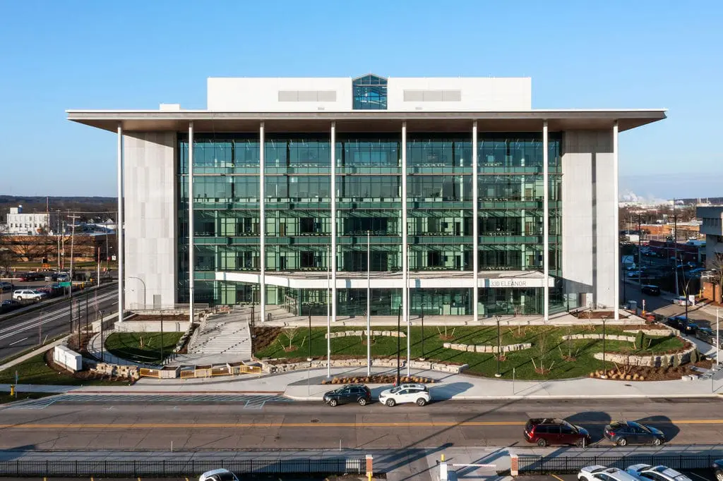 Kalamazoo Justice Center. Exterior view of a modern multi-story building with a glass curtain wall and light-colored rainscreen cladding panels.
