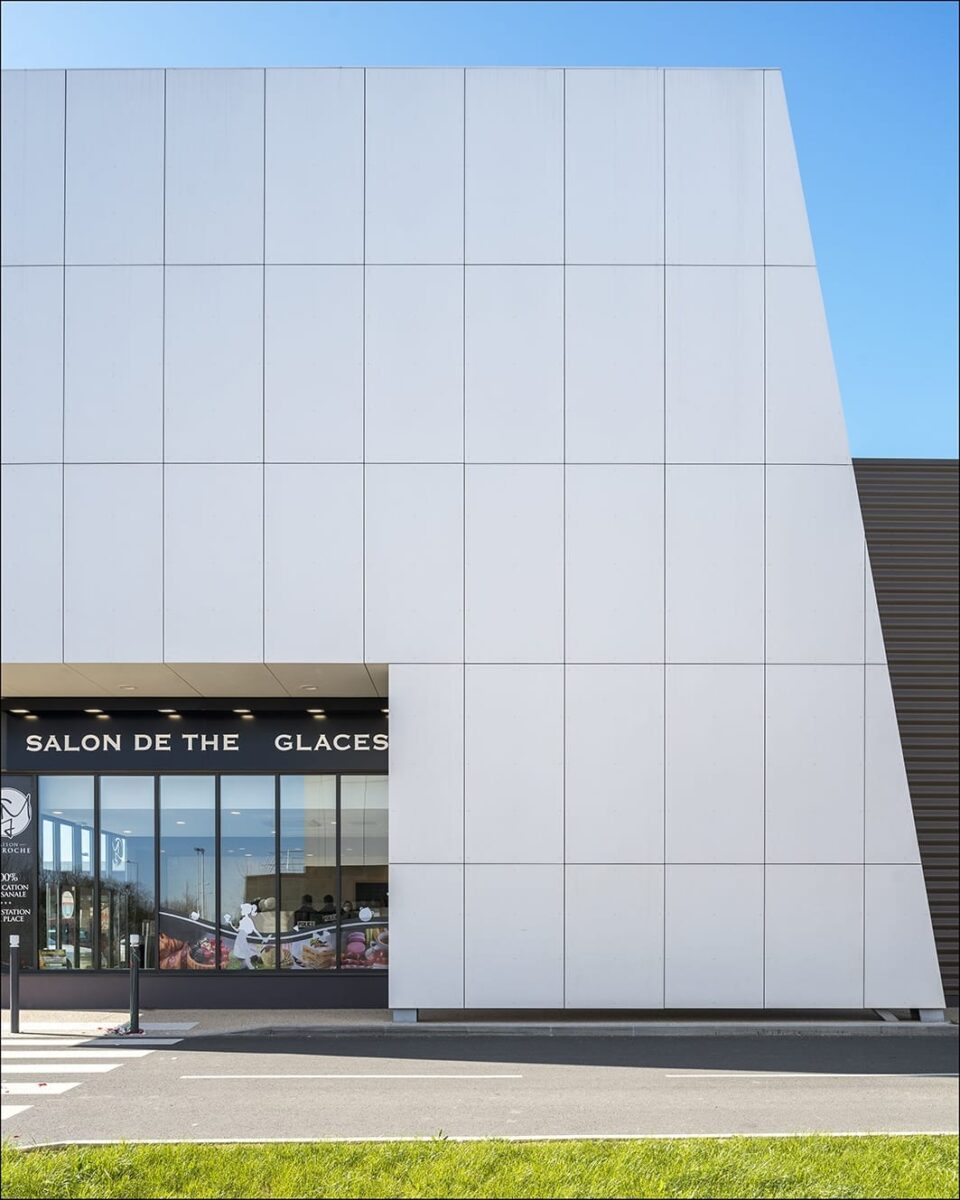 Commercial building with sleek white fiber cement rainscreen panels demonstrating modern façade design and durability.