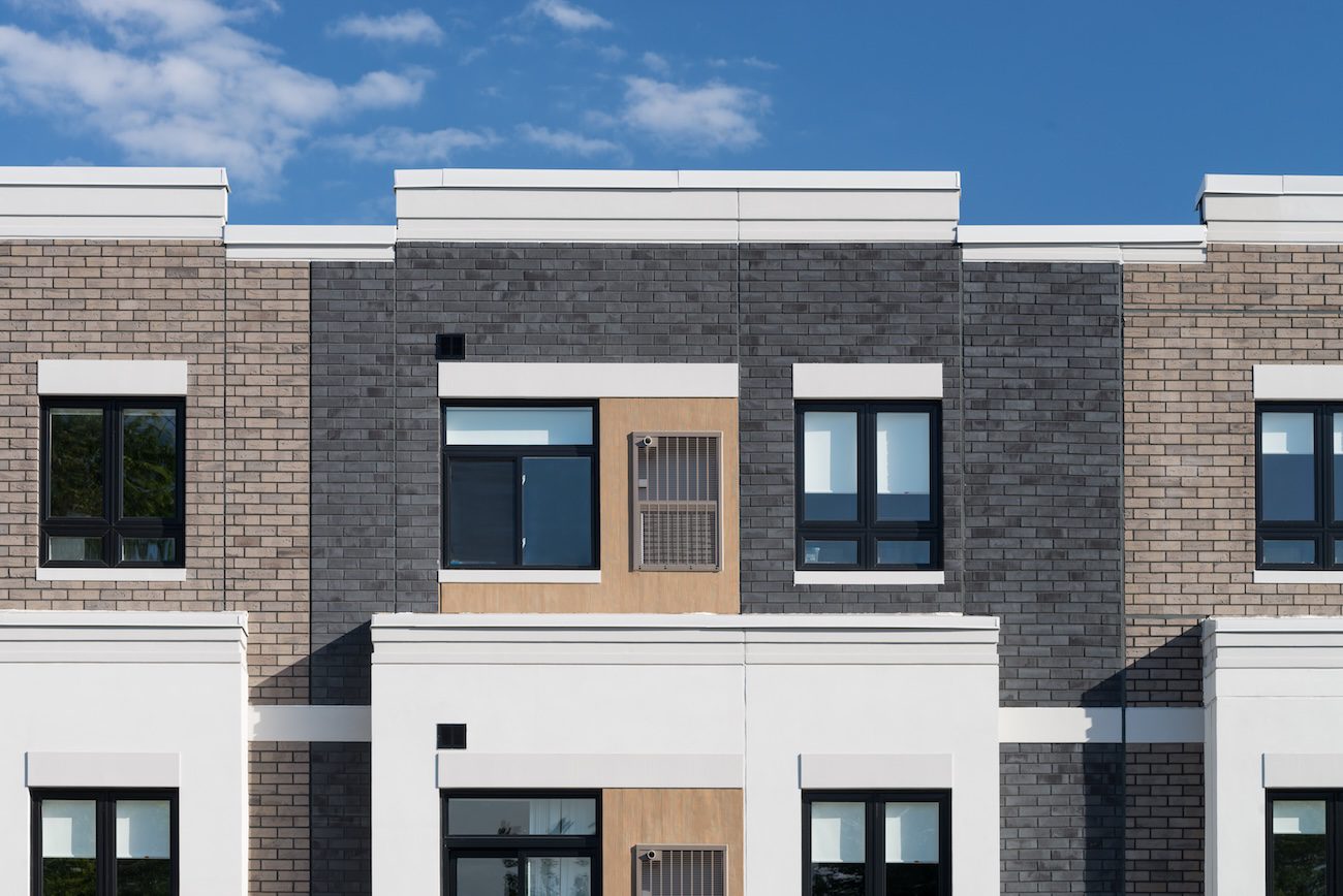 Modern residential façade with brick and EIFS finishes demonstrating StoTherm ci system’s balance of resilience and aesthetics.