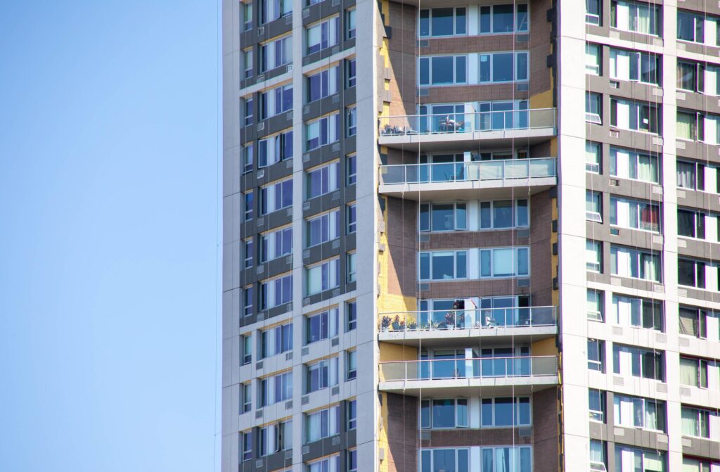 In-progress recladding of The Heritage residential towers using StoTherm ci system.