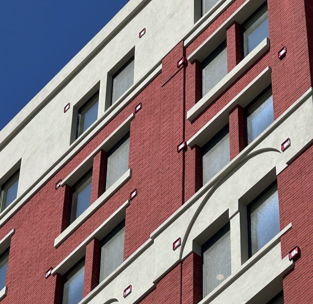 Detailed Red Brick And Stucco Facade Showcasing Traditional Masonry Aesthetics Achievable With Lightweight StoCast Exterior Finishes