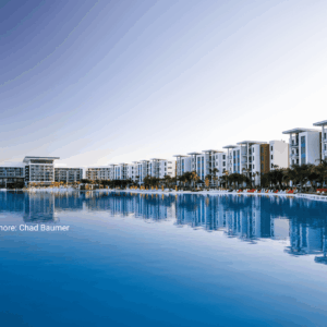 Modern Resort-style Building Facade Reflected In Water, Showing Long-lasting Exterior Color Performance. Photo Credit : Conrad Evermore: Chad Baumer