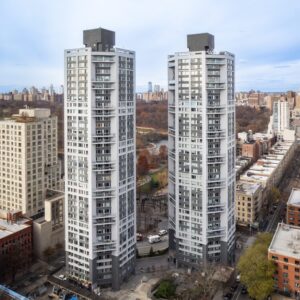 Two High-rise Residential Towers In An Urban Neighborhood, Showing Dense City Housing With Modern Exterior Envelope Systems.