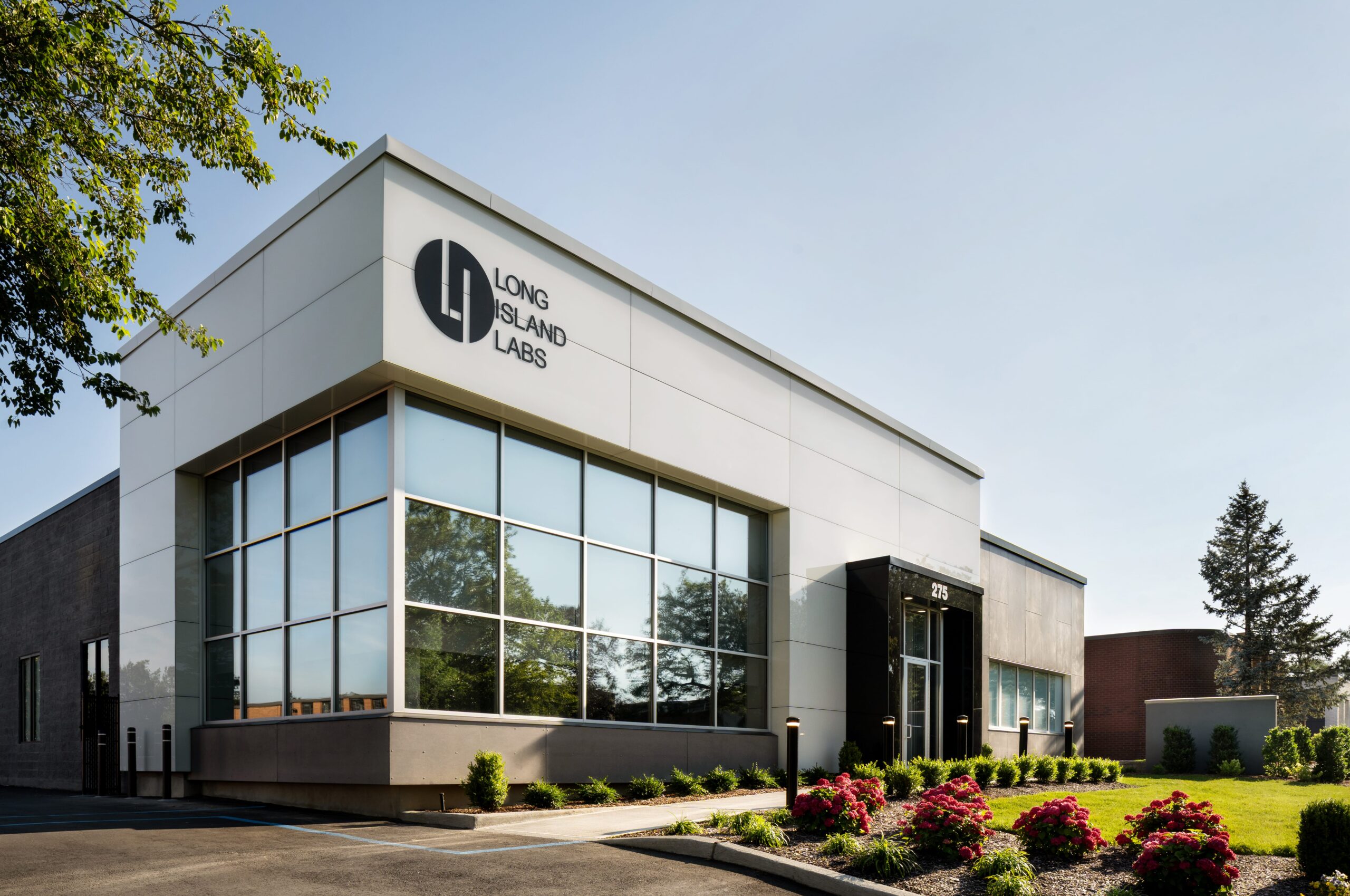 Long Island Labs exterior with large windows, clean panel joints and modern rainscreen cladding.
